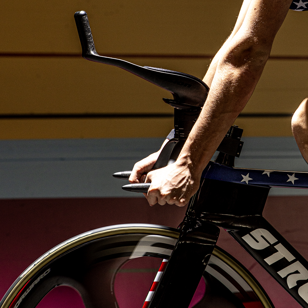 Stromm track bike aerodynamic handlebars gripped by a rider's hands